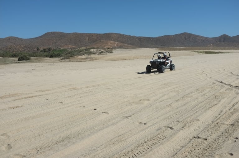 Dune buggy driving on the beach along the Pacific Ocean north of Cabo San Lucas, Baja California Sur, Mexico